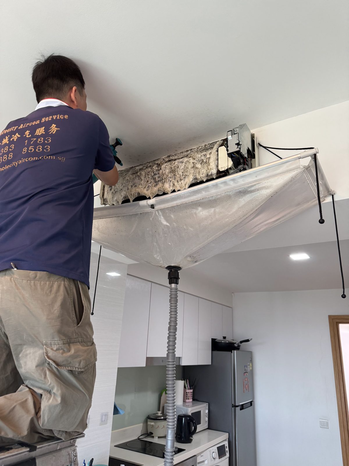 Whole City Aircon Service Pte Ltd on the job in Kallang